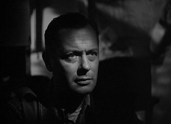 Movie still from “They Were Expendable” (1945), directed by Robert Montgomery – Black and white photograph of a man looking at the camera; Close Up shot, Low angle