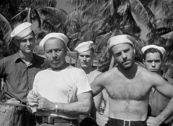 Movie still from “They Were Expendable” (1945), directed by Robert Montgomery – Black and white photograph of a group of men in sailor's hats; Medium shot, Low angle