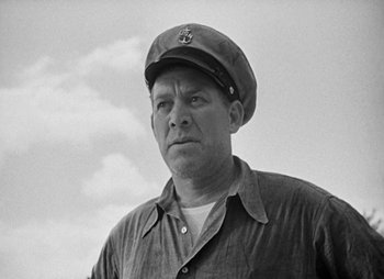 Movie still from “They Were Expendable” (1945), directed by Robert Montgomery – A man wearing a hat and a shirt; Close Up shot, Low angle