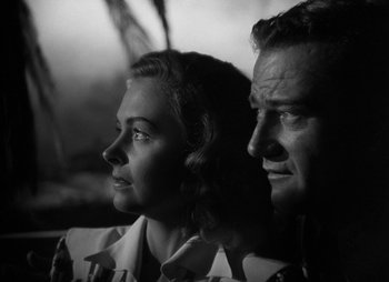 Movie still from “They Were Expendable” (1945), directed by Robert Montgomery – An older man and a younger woman looking into the distance; Close Up shot, Low angle