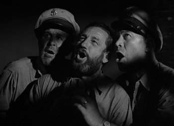 Movie still from “They Were Expendable” (1945), directed by Robert Montgomery – A group of men standing next to each other; Close Up shot, Low angle