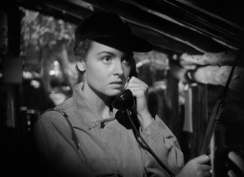Movie still from “They Were Expendable” (1945), directed by Robert Montgomery – A woman wearing a baseball cap talking on a phone; Close Up shot, High angle