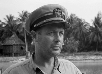 Movie still from “They Were Expendable” (1945), directed by Robert Montgomery – A man wearing a military hat and a shirt; Close Up shot, Low angle