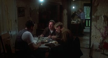 Movie still from “Thieves Like Us” (1974), directed by Robert Altman – A group of people sitting at a table eating; Wide shot, High angle