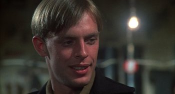 Movie still from “Thieves Like Us” (1974), directed by Robert Altman – A person wearing a jacket; Close Up shot, Over the shoulder angle