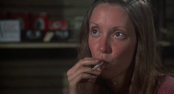 Movie still from “Thieves Like Us” (1974), directed by Robert Altman – A person with a cigarette in her mouth; Close Up shot, Low angle