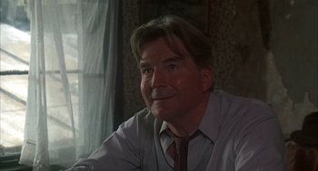 Movie still from “Thieves Like Us” (1974), directed by Robert Altman – A person wearing a shirt and a tie; Close Up shot, Low angle