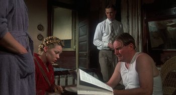 Movie still from “Thieves Like Us” (1974), directed by Robert Altman – A man and a woman looking at a newspaper; Medium shot, Over the shoulder angle