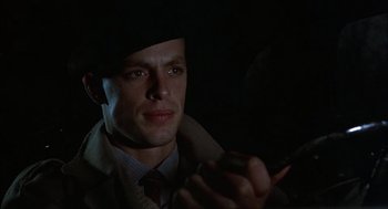 Movie still from “Thieves Like Us” (1974), directed by Robert Altman – A man wearing a hat and holding a cell phone; Close Up shot, Low angle