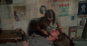 Movie still from “Thieves Like Us” (1974), directed by Robert Altman – A man laying on a bed with a woman; Medium shot, Overhead angle