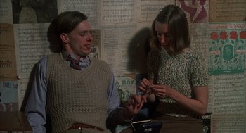 Movie still from “Thieves Like Us” (1974), directed by Robert Altman – A man and a woman sitting at a table; Medium shot, High angle
