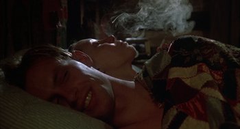 Movie still from “Thieves Like Us” (1974), directed by Robert Altman – Two people laying in bed with smoke coming out of their mouths; Close Up shot, Low angle
