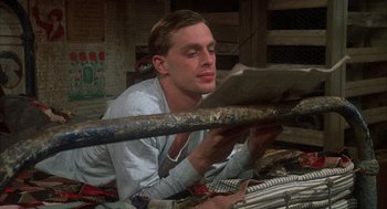 Movie still from “Thieves Like Us” (1974), directed by Robert Altman – A man is reading a newspaper in a room; Close Up shot, Low angle