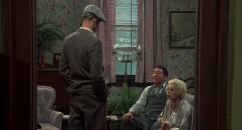 Movie still from “Thieves Like Us” (1974), directed by Robert Altman – A group of people sitting in a living room; Medium shot, High angle