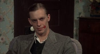 Movie still from “Thieves Like Us” (1974), directed by Robert Altman – A man with a red nose painted on his face; Close Up shot, Low angle