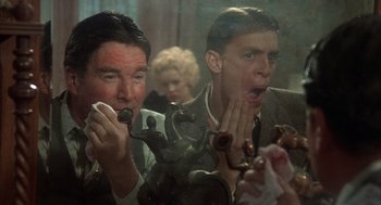 Movie still from “Thieves Like Us” (1974), directed by Robert Altman – Two men are brushing their teeth in the mirror; Close Up shot, Low angle