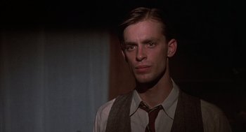 Movie still from “Thieves Like Us” (1974), directed by Robert Altman – A man wearing a vest and a neck tie; Close Up shot, Low angle