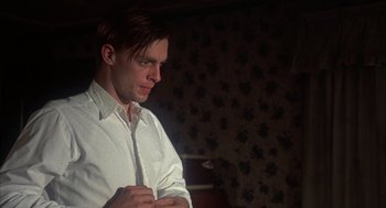 Movie still from “Thieves Like Us” (1974), directed by Robert Altman – A man in a white dress shirt is looking down; Close Up shot, Low angle