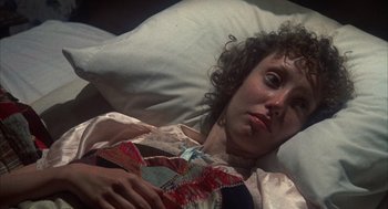 Movie still from “Thieves Like Us” (1974), directed by Robert Altman – A woman laying in a bed holding a pillow; Close Up shot, High angle
