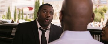 Movie still from “Think Like a Man Too” (2014), directed by Tim Story – A man in a suit and tie looking at another man in a suit and tie; Close Up shot, Over the shoulder angle