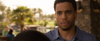 Movie still from “Think Like a Man Too” (2014), directed by Tim Story – A person with a car in the background; Close Up shot, Over the shoulder angle
