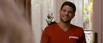 Movie still from “Think Like a Man Too” (2014), directed by Tim Story – A man in a red shirt smiling for the camera; Close Up shot, Over the shoulder angle