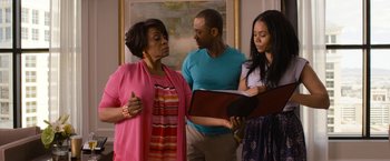 Movie still from “Think Like a Man Too” (2014), directed by Tim Story – A group of people standing in a living room together; Medium shot, Over the shoulder angle