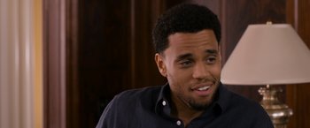 Movie still from “Think Like a Man Too” (2014), directed by Tim Story – A person sitting in a room; Close Up shot, Over the shoulder angle