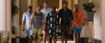 Movie still from “Think Like a Man Too” (2014), directed by Tim Story – A group of men walking down a hall way; Wide shot, High angle