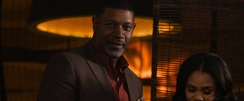 Movie still from “Think Like a Man Too” (2014), directed by Tim Story – A man wearing a suit and a red shirt; Close Up shot, Over the shoulder angle