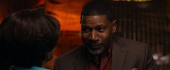 Movie still from “Think Like a Man Too” (2014), directed by Tim Story – A person wearing a suit and tie; Close Up shot, Over the shoulder angle