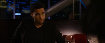 Movie still from “Think Like a Man Too” (2014), directed by Tim Story – A man sitting in front of a glass of wine; Close Up shot, Over the shoulder angle