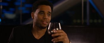 Movie still from “Think Like a Man Too” (2014), directed by Tim Story – A person holding a glass of wine; Close Up shot, Over the shoulder angle