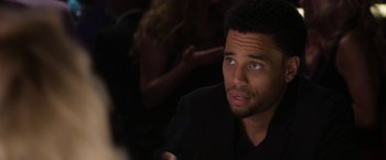 Movie still from “Think Like a Man Too” (2014), directed by Tim Story – A person sitting at a table; Close Up shot, Over the shoulder angle