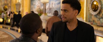 Movie still from “Think Like a Man Too” (2014), directed by Tim Story – A man in a suit talking to another man in a black suit; Close Up shot, Over the shoulder angle