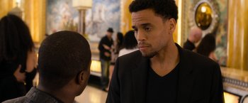 Movie still from “Think Like a Man Too” (2014), directed by Tim Story – A man in a black jacket talking to another man in a black suit; Close Up shot, Over the shoulder angle
