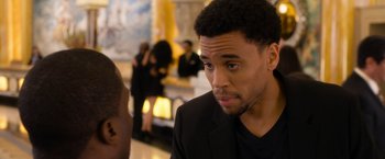 Movie still from “Think Like a Man Too” (2014), directed by Tim Story – A person wearing a suit and tie; Close Up shot, Over the shoulder angle