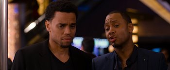 Movie still from “Think Like a Man Too” (2014), directed by Tim Story – A couple of men standing next to each other; Close Up shot, Over the shoulder angle