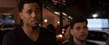 Movie still from “Think Like a Man Too” (2014), directed by Tim Story – Two men are sitting in front of some lights; Close Up shot, Over the shoulder angle