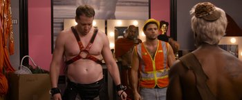 Movie still from “Think Like a Man Too” (2014), directed by Tim Story – Two men in red and orange vests and one man in a hard hat; Medium shot, Over the shoulder angle