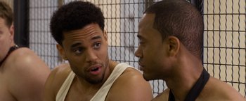 Movie still from “Think Like a Man Too” (2014), directed by Tim Story – Two men talking to each other in front of a fence; Close Up shot, Over the shoulder angle