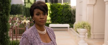 Movie still from “Think Like a Man Too” (2014), directed by Tim Story – An older woman wearing a purple dress and pearl necklace; Close Up shot, Over the shoulder angle