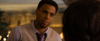 Movie still from “Think Like a Man Too” (2014), directed by Tim Story – A person wearing a suit and a tie; Close Up shot, Over the shoulder angle