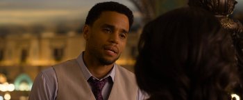 Movie still from “Think Like a Man Too” (2014), directed by Tim Story – A man wearing a vest and a neck tie; Close Up shot, Over the shoulder angle