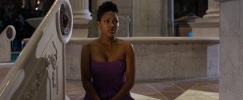 Movie still from “Think Like a Man Too” (2014), directed by Tim Story – A woman sitting on the ground wearing a purple dress; Medium shot, Over the shoulder angle