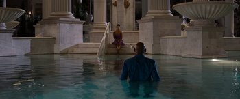 Movie still from “Think Like a Man Too” (2014), directed by Tim Story – A man and a woman sitting on steps in the water; Extreme Wide shot, Over the shoulder angle