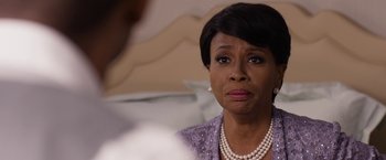 Movie still from “Think Like a Man Too” (2014), directed by Tim Story – An older woman wearing pearls and a purple jacket; Close Up shot, Over the shoulder angle