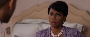 Movie still from “Think Like a Man Too” (2014), directed by Tim Story – A woman that is sitting in front of a bed; Close Up shot, Over the shoulder angle