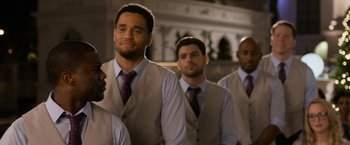 Movie still from “Think Like a Man Too” (2014), directed by Tim Story – A group of men standing next to each other in a room; Medium shot, Over the shoulder angle