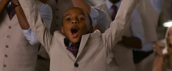 Movie still from “Think Like a Man Too” (2014), directed by Tim Story – A boy in a suit and tie with his mouth wide open; Close Up shot, Low angle